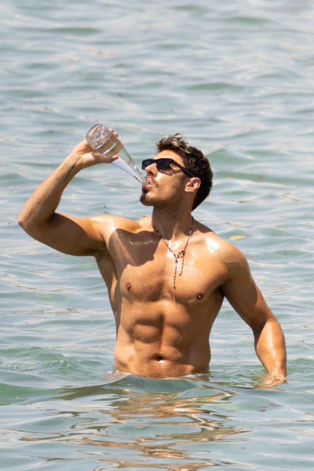 Chris Appleton drinking water in the ocean.