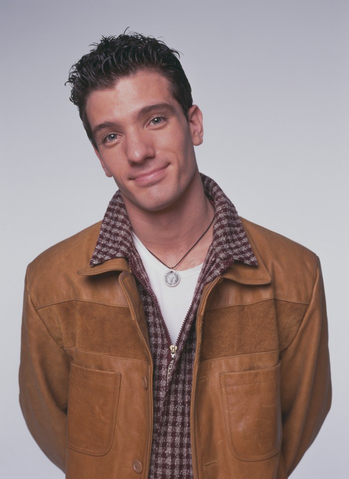 Portrait of JC Chasez in a brown leather jacket.
