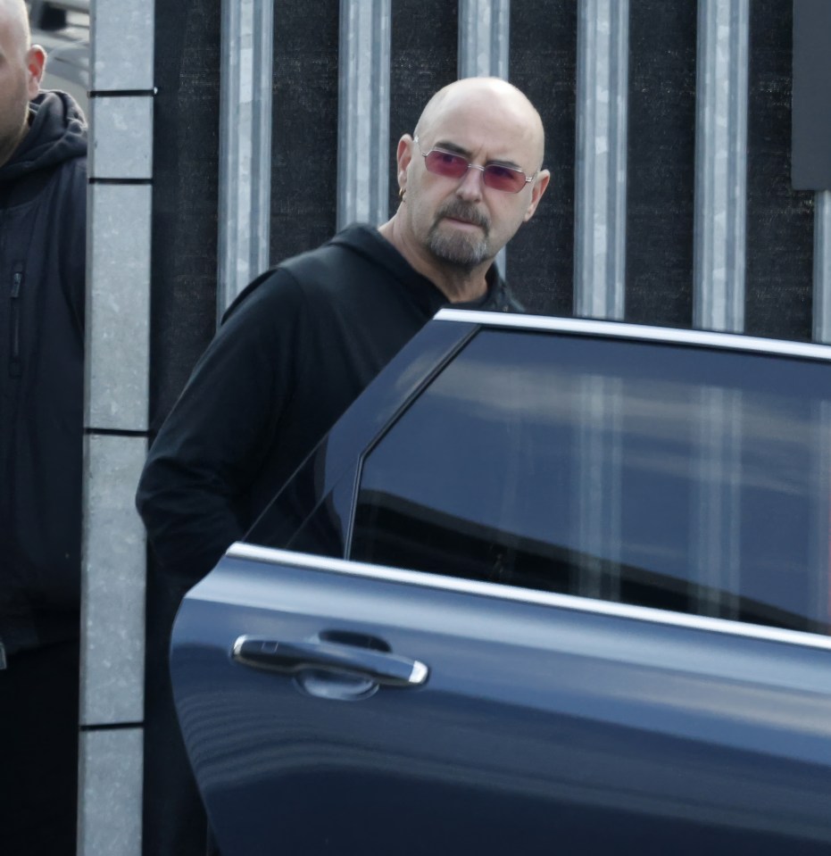 Oasis band member getting into a car.