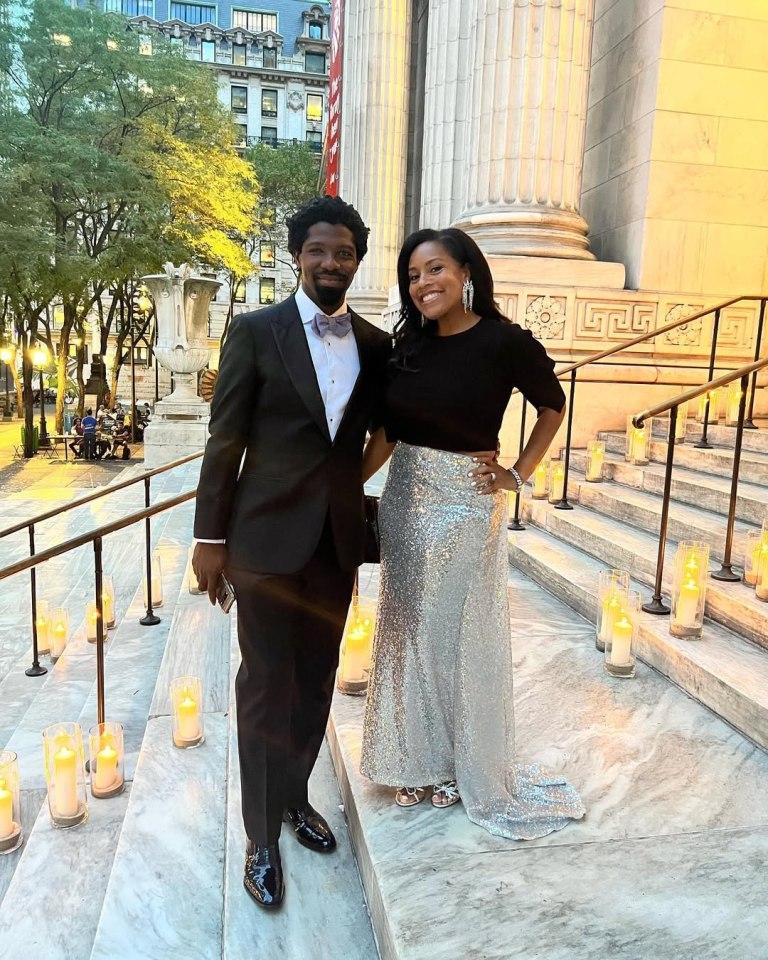 Couple posing on steps lit with candles.