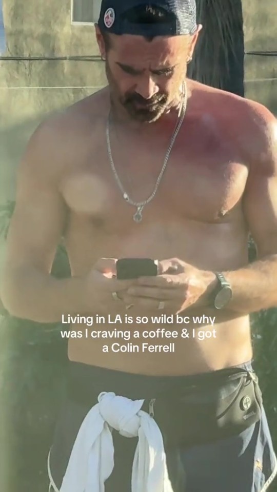 Shirtless man using phone.