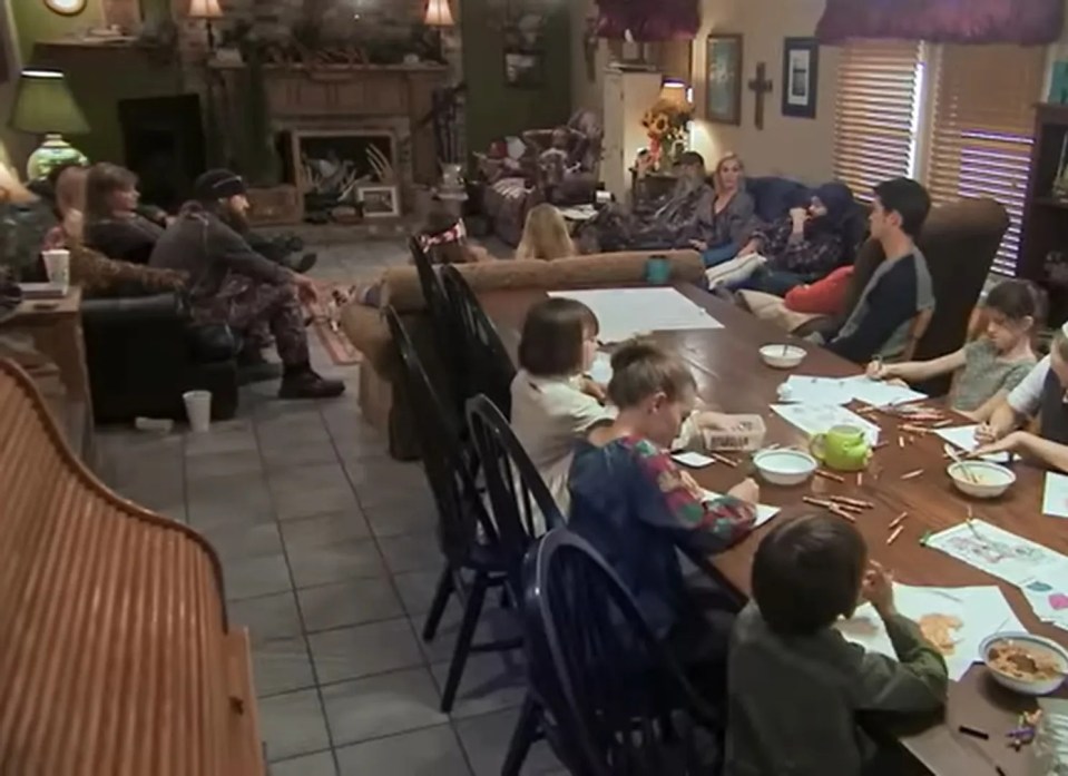 The Robertson family gathered around a long table, children coloring.