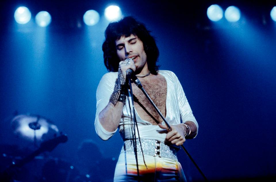 Freddie Mercury of Queen performing on stage.