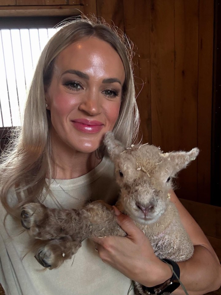 Carrie Underwood holding a lamb.