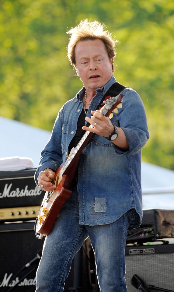 Rick Derringer playing guitar at a music festival.