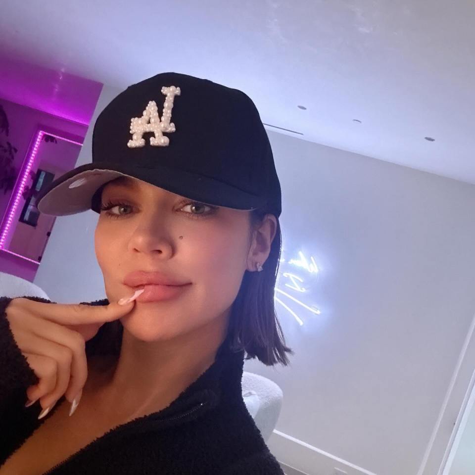 Khloe Kardashian wearing a black baseball cap.