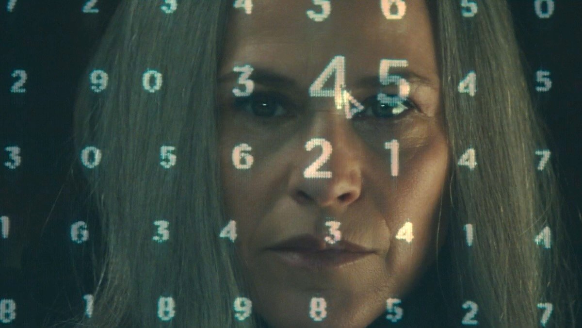 Harmony Cobel with MDR numbers super imposed on her face on Severance