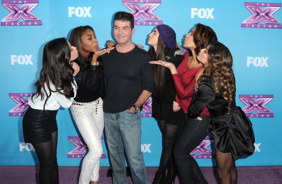 Simon Cowell with Fifth Harmony at the X Factor finale press conference.