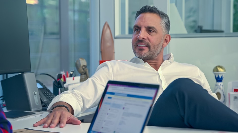 Mauricio Umansky sitting at his desk in a white shirt.