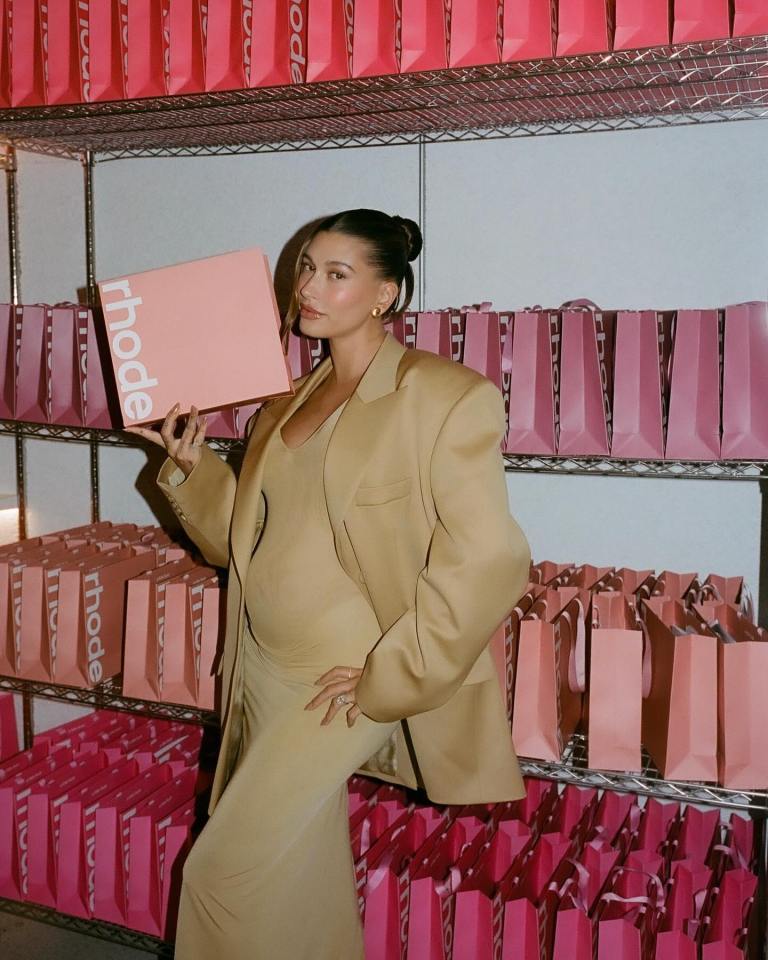 Hailey Bieber at Rhode pop-up shop holding a Rhode box.