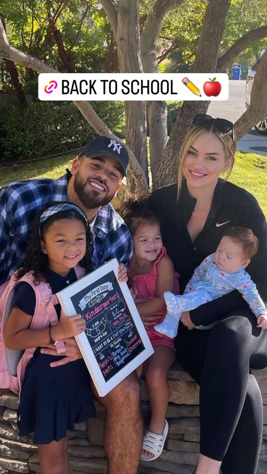 Family photo celebrating a child's first day of kindergarten.