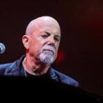 Billy Joel performing on stage.