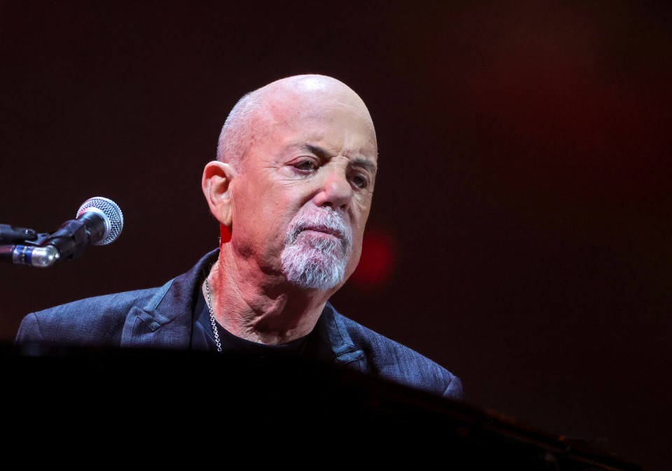 Billy Joel performing on stage.