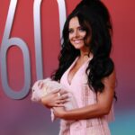Jessie Murph at the Academy of Country Music Awards holding a small pig.