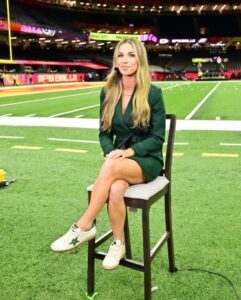 Erin Dolan sitting on a stool at a Super Bowl event.