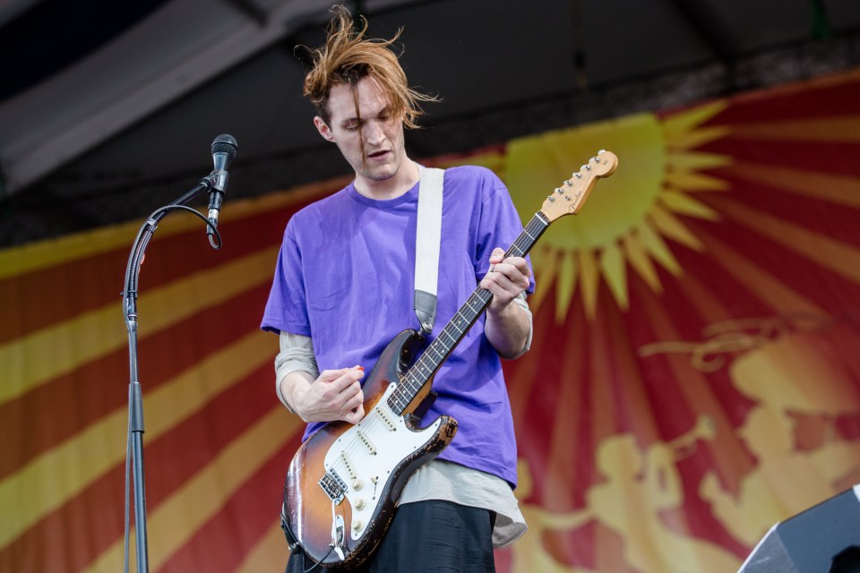 Josh Klinghoffer of the Red Hot Chili Peppers playing guitar at the New Orleans Jazz & Heritage Festival.