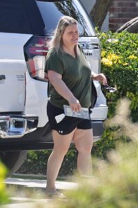 Brooke Thompson, aka "Pumpkin," walking near a vehicle.