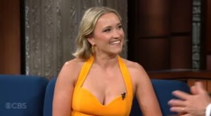 Emily Osment wearing a yellow dress.