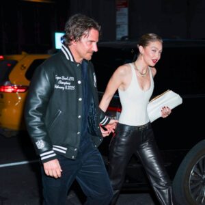 Bradley Cooper and Gigi Hadid holding hands.