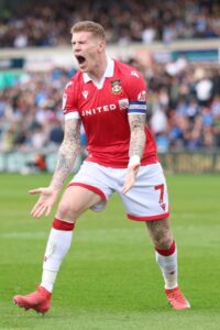 James McClean of Wrexham appeals during a soccer game.