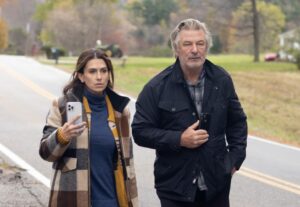 Alec Baldwin and Hilaria Baldwin walking down a road.