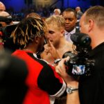 Jake Paul and KSI arguing after a boxing match.