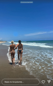 Olivia Dunne links arms with her sister Julz at the beach.