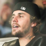 Justin Bieber wearing a black hat at the Super Bowl