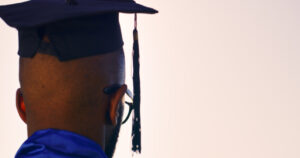 Rear View of Graduate Wearing Cap and Gown Symbolizing Achievement and Future Aspirations