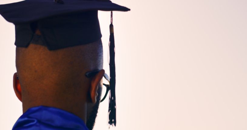 Rear View of Graduate Wearing Cap and Gown Symbolizing Achievement and Future Aspirations