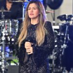 Kelly Clarkson performing at a concert.