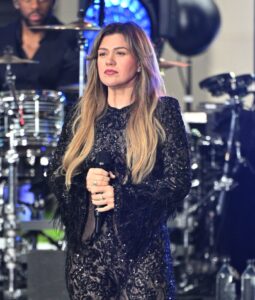 Kelly Clarkson performing at a concert.