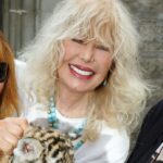 Martine Collette holding a tiger cub.