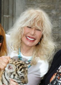Martine Collette holding a tiger cub.