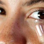 person-inserting-contact-lens-into-eye
