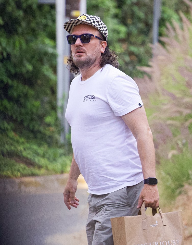 JC Chasez carrying a takeout bag.