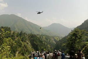 A helicopter aids in the rescue of stranded kids in Pakistan.