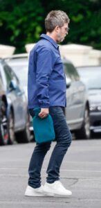 Noel Gallagher carrying a hot water bottle.