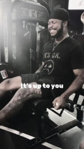 Black and white photo of Kirk Medas working out on a leg press machine.