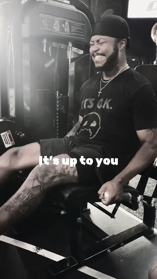 Black and white photo of Kirk Medas working out on a leg press machine.