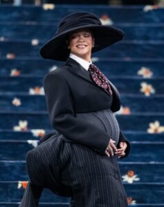 Rihanna at the Met Gala in a black suit and wide-brimmed hat.
