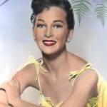 Portrait of Taina Elg in a yellow dress.