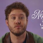 A man with curly hair and a beard against a purple background; text overlay reads "Nepo Baby (257 MONTHS)".