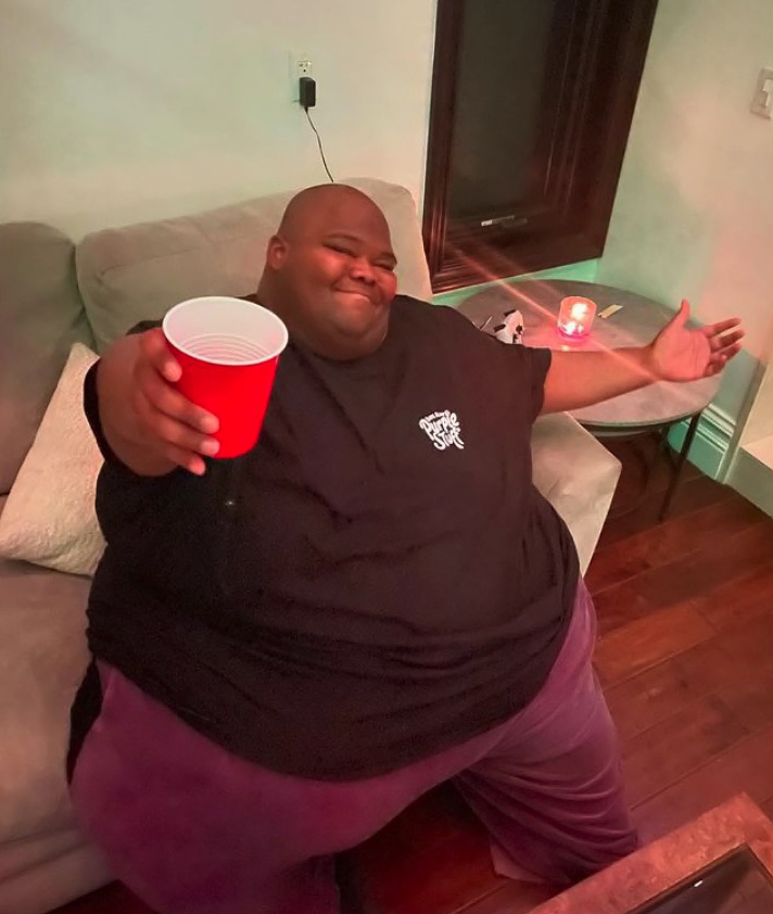 Dave Blunts holding a red cup at a Juice Wrld tribute show.