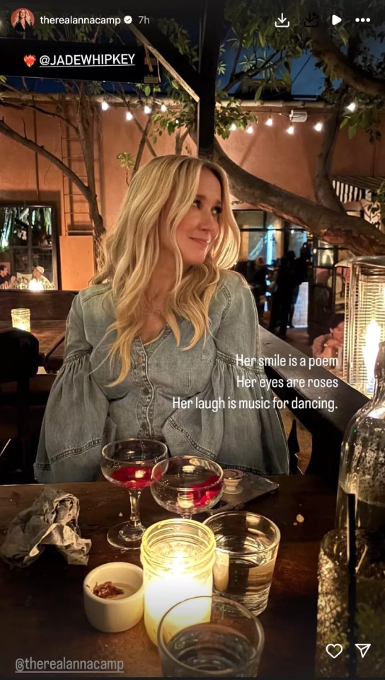Anna Camp at a restaurant with candles and drinks.