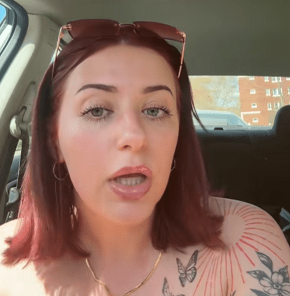 Woman in car discussing oil changes.