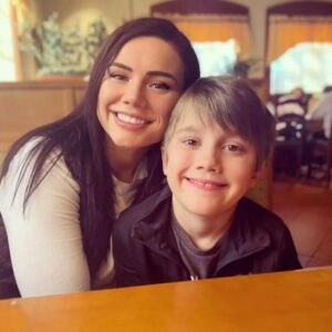 Woman and boy smiling together.