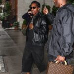 A$AP Rocky walking in the rain, looking glum.