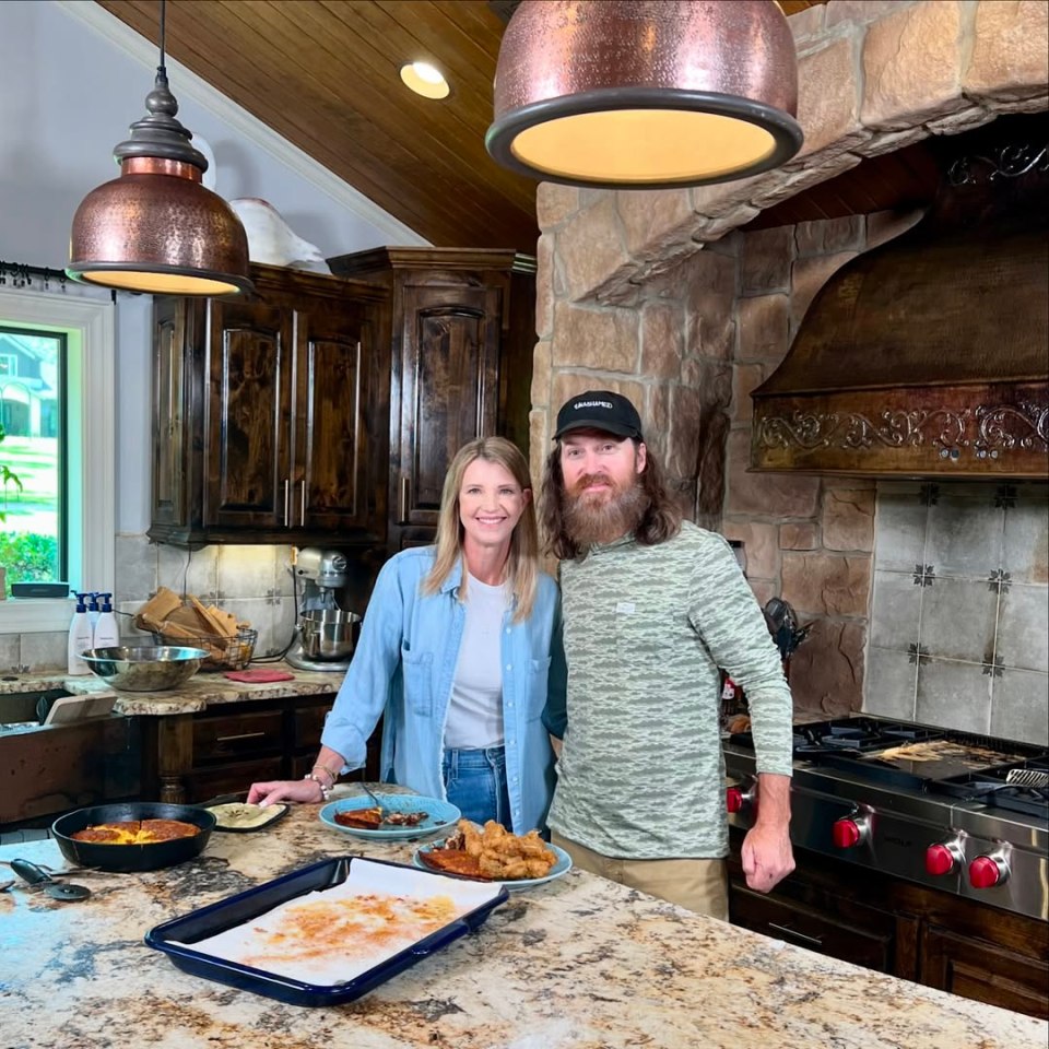 Jason and Missy Robertson in their kitchen, preparing food.
