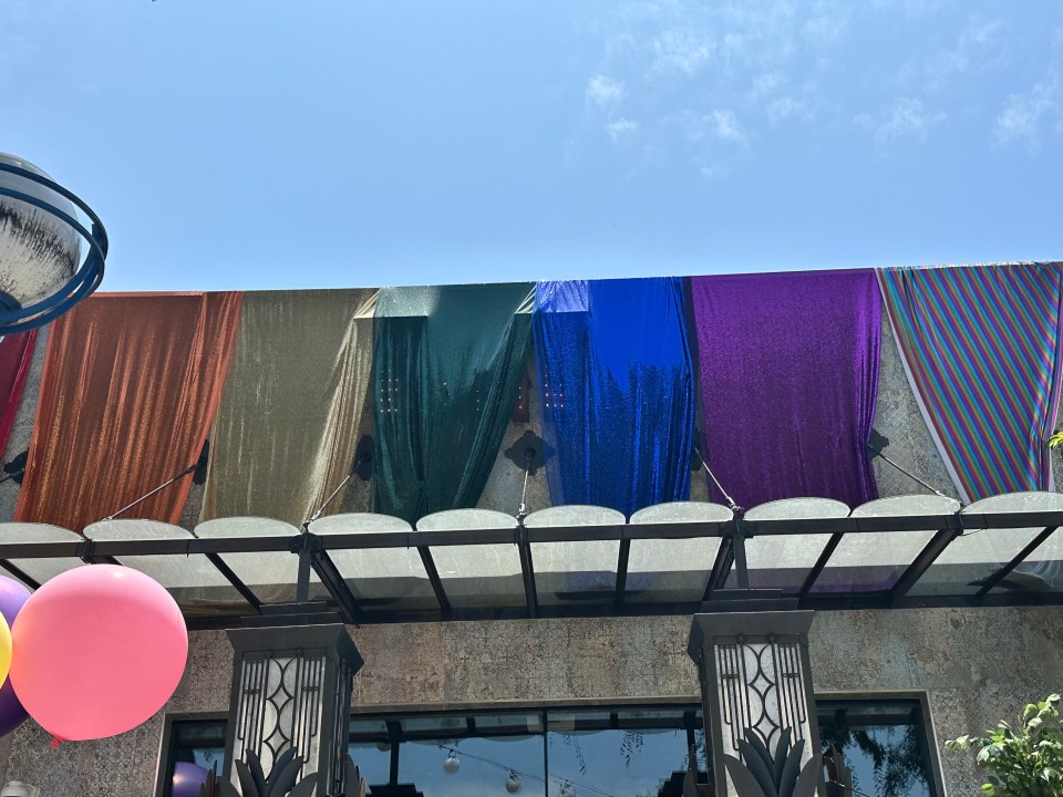 Rainbow-colored fabric draped over a building's facade.